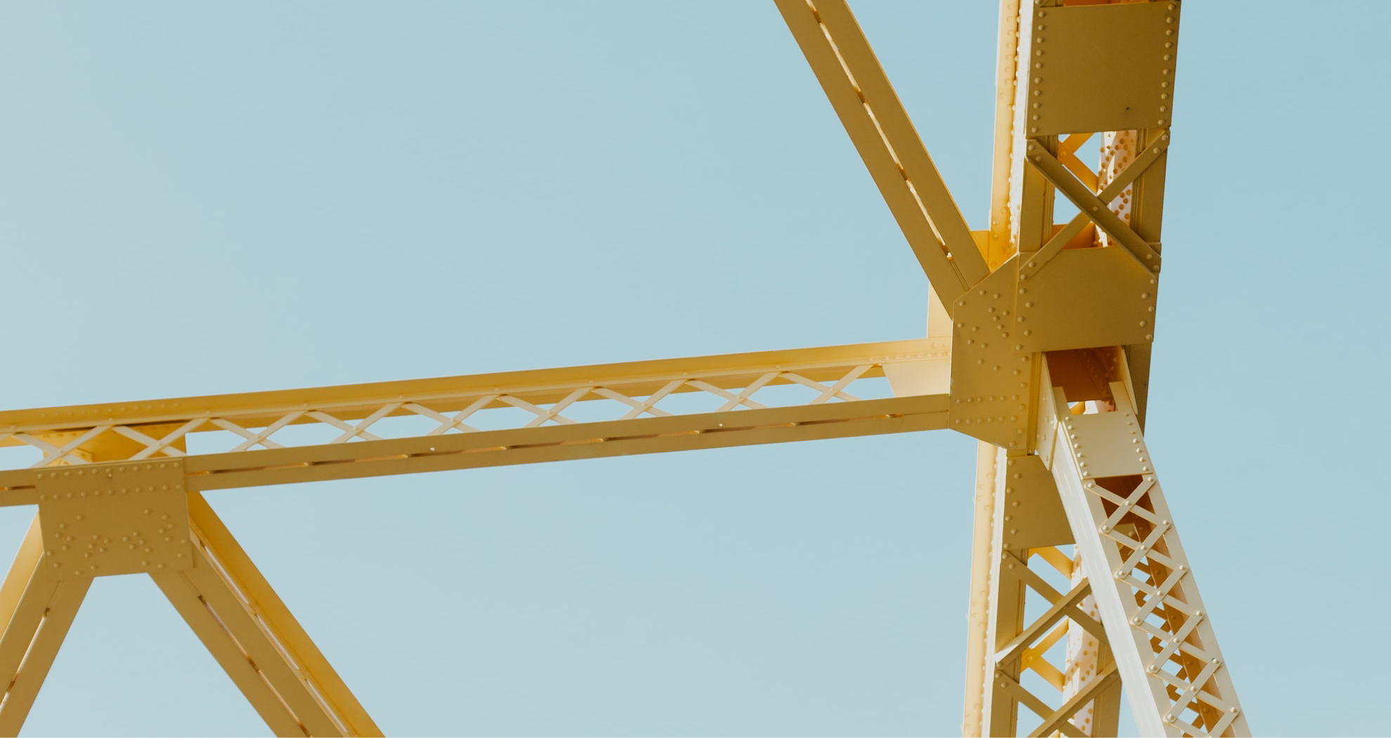 Steel truss structure against a clear blue sky